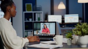 african-businesswoman-discussing-with-remotely-woman-partner-online-sitting-front-laptop-working-start-up-office-talking-video-call-during-virtual-meeting-midnight-using-headphone-300x169